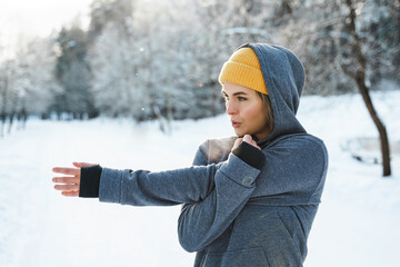 Young athletic woman warming up before her winter workout