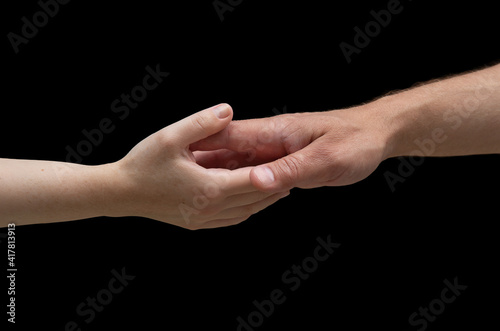 hands of invisible Caucasian people stretch towards each other. isolated on a black background