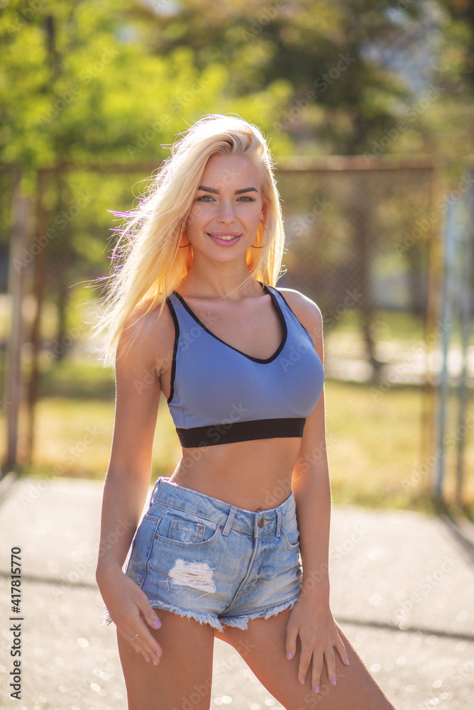 Smiling fitness woman posing at the playground Smiling fitness woman posing at the playground