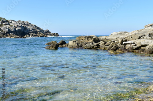 Obraz na płótnie Beach with rocks, transparent water and blue sky at Rias Baixas Region. Galicia, Spain. w salonie