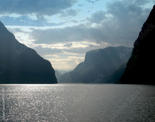 Fjord landscape with sea mountains and sky. 