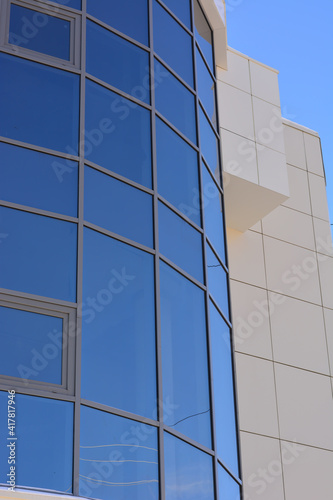 fragment of the wall of a modern business center. blue sky background.