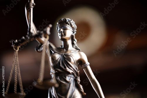 Law concept. Lawyer office. Themis statue on the shelf with legal books background.  © zolnierek
