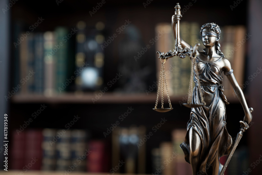Law concept. Lawyer office. Themis statue on the shelf with legal books background. Law concept. Lawyer office. Themis statue on the shelf with legal books background.