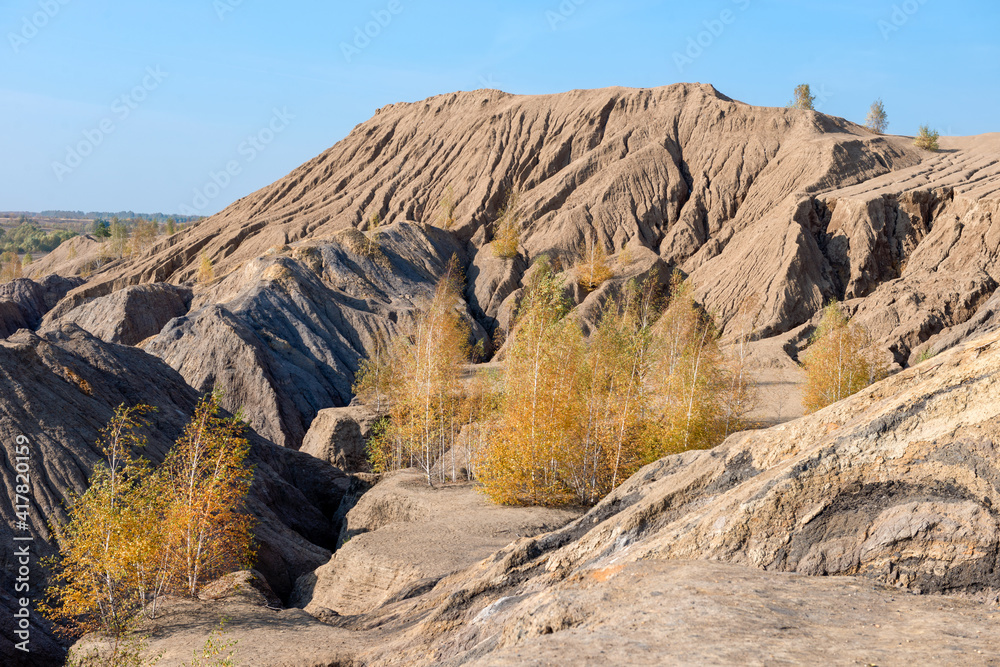 Obraz premium Konduki, Tula region, Romancevskie mountains, Abandoned Ushakov quarries. The mud erosion of the soil looks like mountains. The area is overgrown with young birches. Beautiful natural landscape