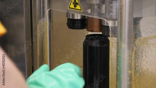 The process of capping aluminum cans in the beer industry.