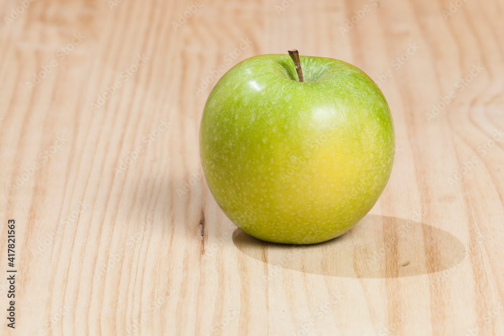 Tasty green apple; photo on wooden background. Tasty green apple; photo on wooden background.