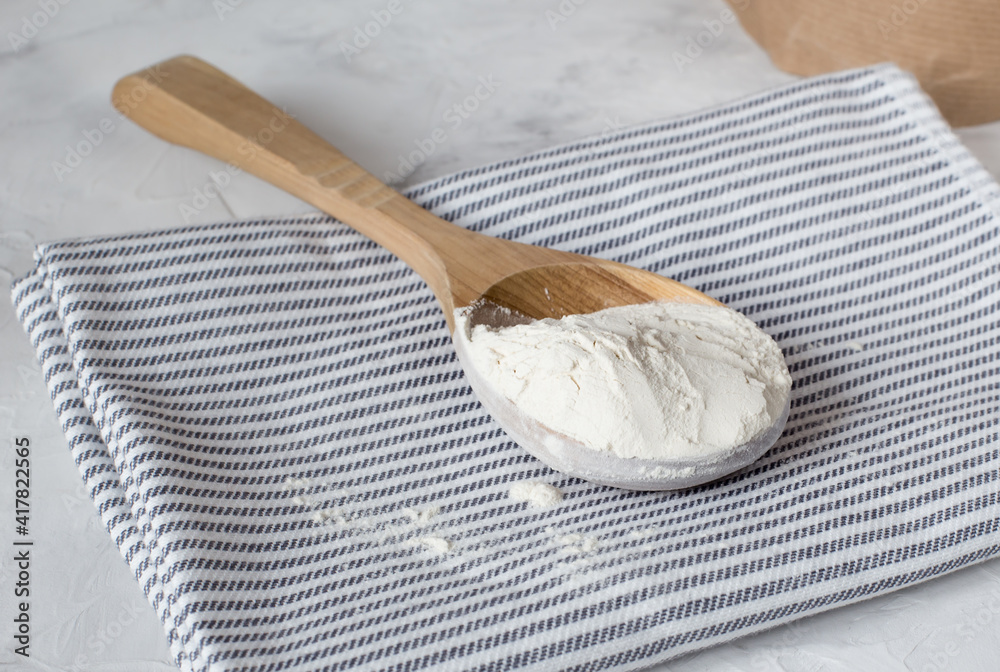 Crumbly xanthan gum in a wooden spoon. Crumbly xanthan gum in a wooden spoon.