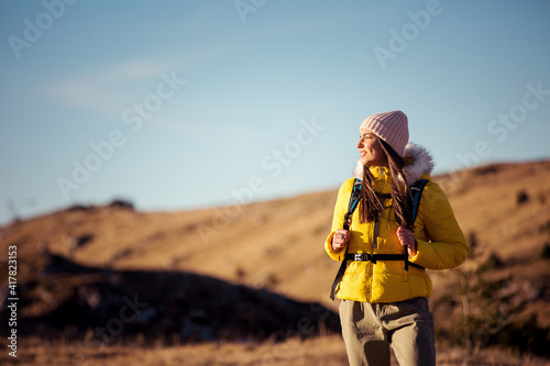 Happy female mountaineer sightseeing in nature