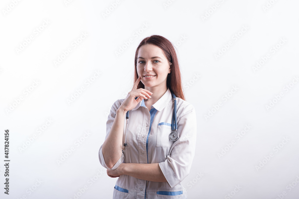 Portrait of a female doctor in a white uniform who thinks in the studio on a white background Portrait of a female doctor in a white uniform who thinks in the studio on a white background