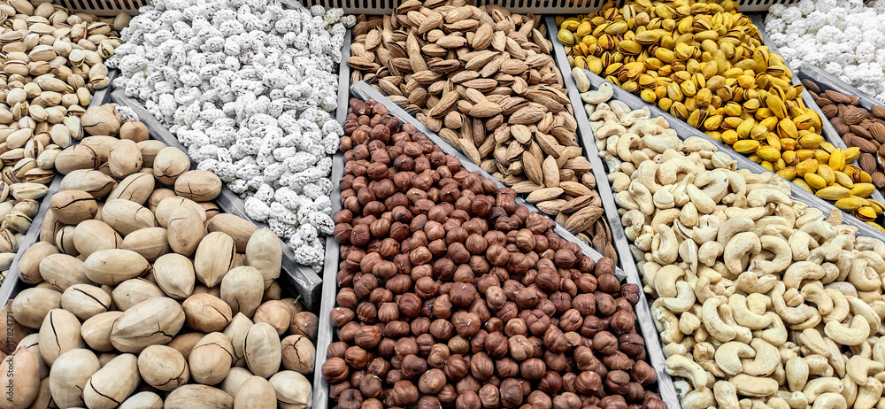 Variuos dried nuts on a market counter Variuos dried nuts on a market counter