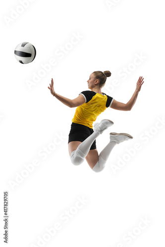 Flying. Young female volleyball player isolated on white studio background. Woman in sportswear training and practicing in action, flight. Concept of sport, healthy lifestyle, motion and movement.