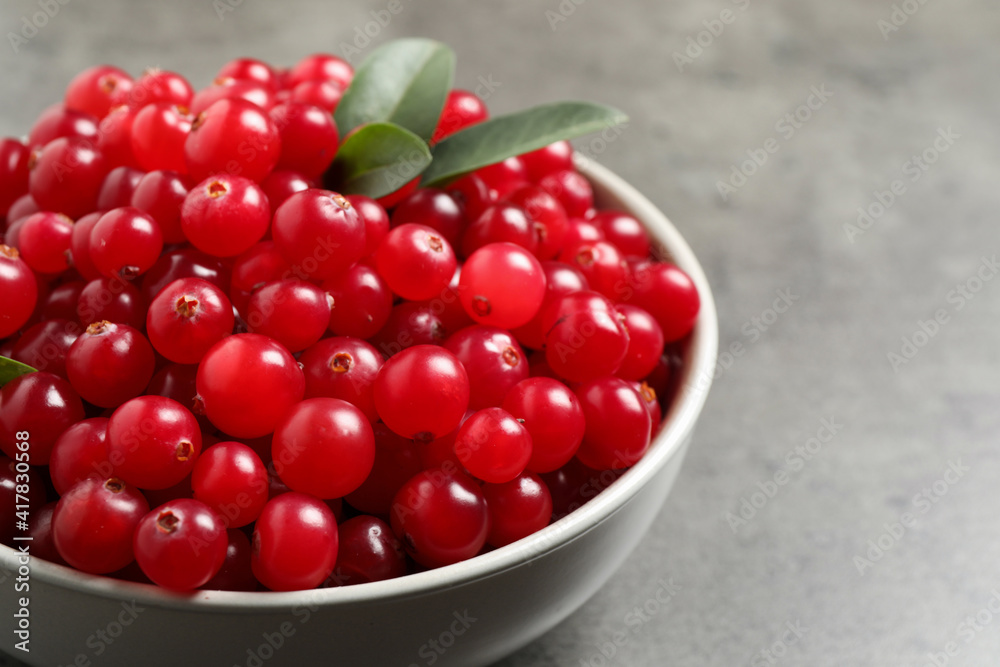 Ripe fresh cranberry on grey table, closeup Ripe fresh cranberry on grey table, closeup