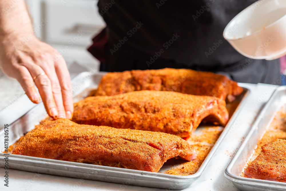 Chef puts spices on the raw piece of meat