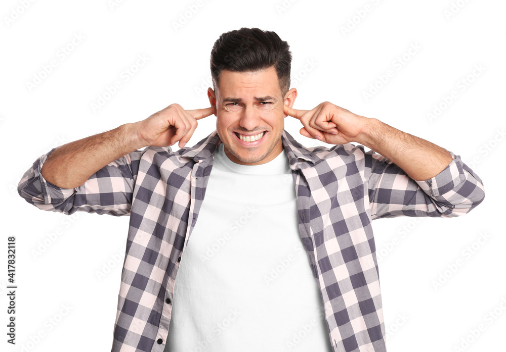 Emotional man covering ears with fingers on white background Emotional man covering ears with fingers on white background