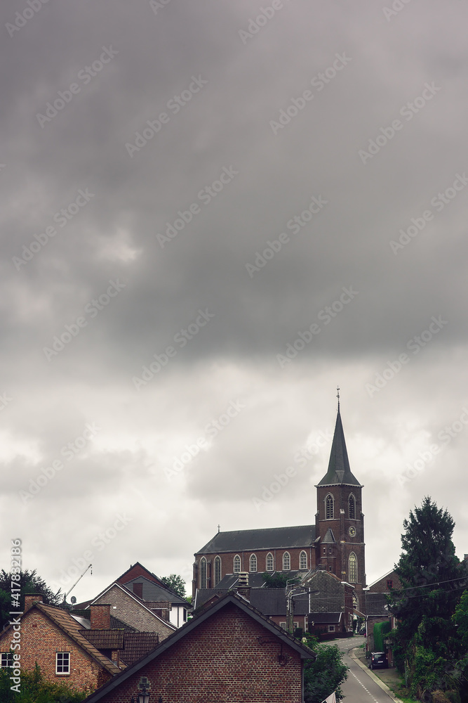Church in rural village under clouded sky. Church in rural village under clouded sky.