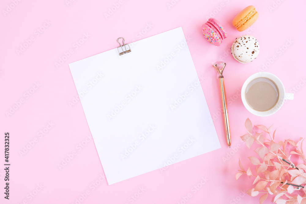Notebook, cup of coffee and colorful macaron on pastel pink desk top view. Cozy morning breakfast. Fashion flat lay. Sweet macaroons. Notebook, cup of coffee and colorful macaron on pastel pink desk top view. Cozy morning breakfast. Fashion flat lay. Sweet macaroons.