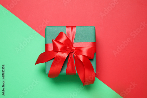 Gift box on color background, top view