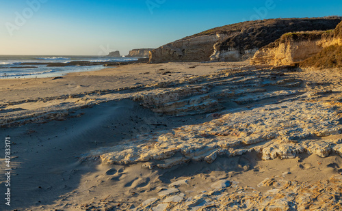Beautiful landscapes of the Pacific coast, beach with human footprints, rocks, waves, sky, sun. Santa Cruz and Davenport have some of the most beautiful beaches in California.