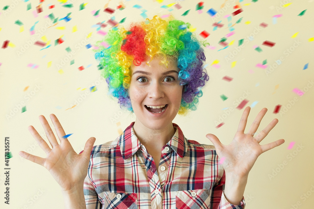 Fototapeta premium Woman in colored wig celebrating fools day, April 1st concept