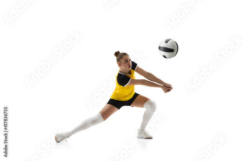 Ready. Young female volleyball player isolated on white studio background. Woman in sportswear training and practicing in action, flight. Concept of sport, healthy lifestyle, motion and movement.