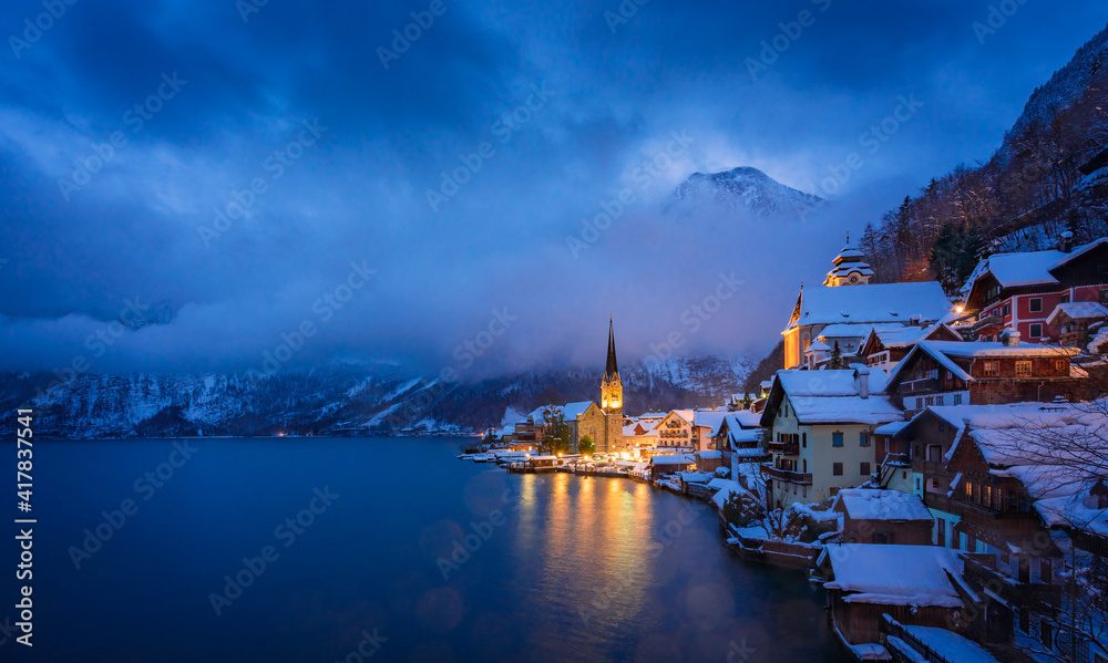 Beautiful Hallstatt lakeside town in twilight during blue hour, Winter season, Austria