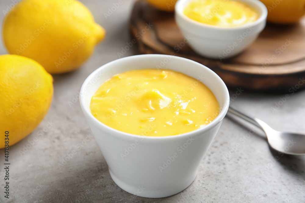 Delicious lemon curd in bowl on grey table, closeup Delicious lemon curd in bowl on grey table, closeup