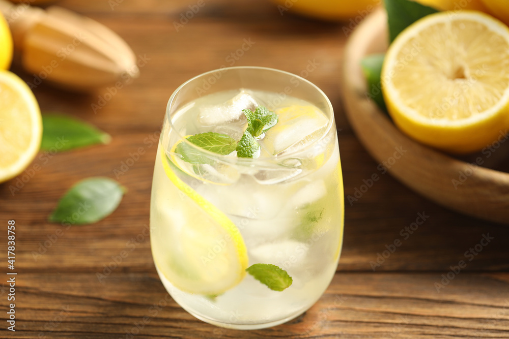 Cool freshly made lemonade in glass on wooden table, closeup Cool freshly made lemonade in glass on wooden table, closeup