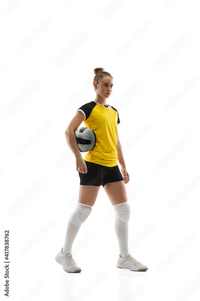 Leader. Young female volleyball player isolated on white studio background. Woman in sportswear training and practicing in action, flight. Concept of sport, healthy lifestyle, motion and movement.