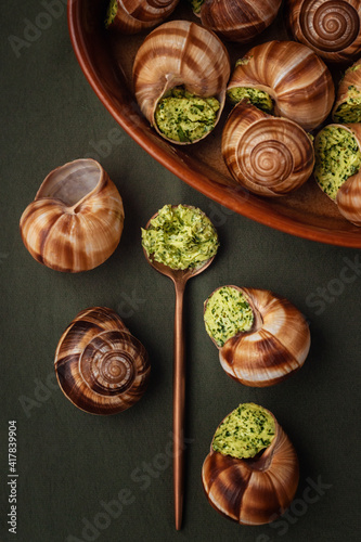 escargot stuffed in sauce on a green table