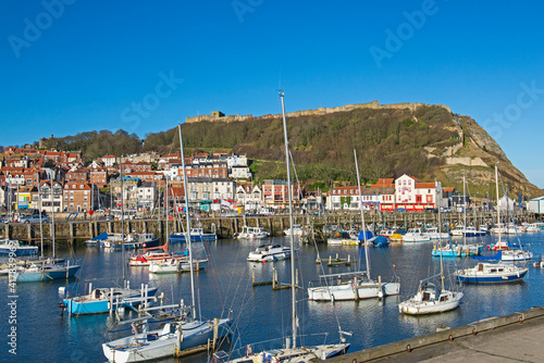 Harbor seafront town with castle on hill