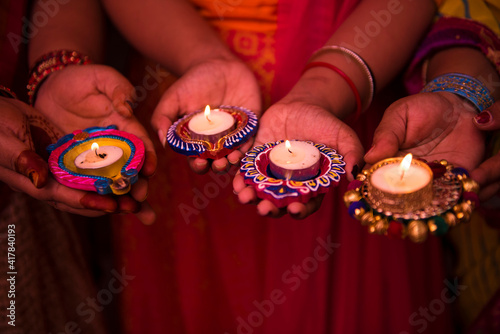 Katni / India 19 October 2017 Women holding diya or oil lamp on hand during diwali festival in Katni Madhya Pradesh India