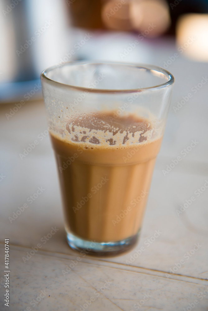 Katni / India 22 October 2017 Half glass of Indian Tea or.Chai is served in a tea glass by vendors at Katni Madhya Pradesh India Katni / India 22 October 2017 Half glass of Indian Tea or.Chai is served in a tea glass by vendors at Katni Madhya Pradesh India