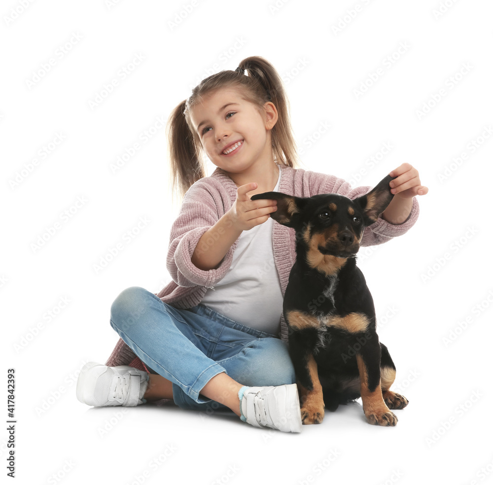 Little girl with cute puppy on white background
