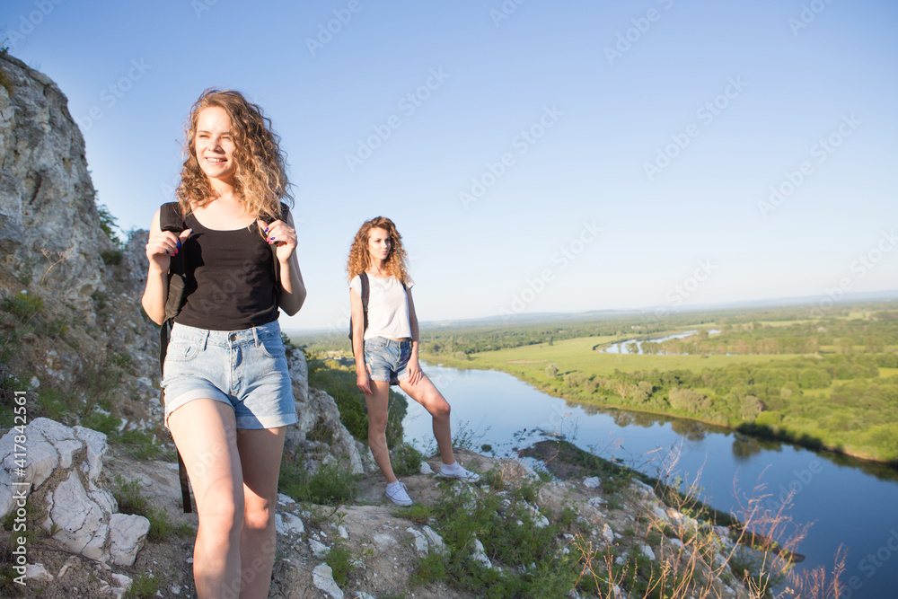Two girls hiking in the mountains. Nature and healthy lifestyle Two girls hiking in the mountains. Nature and healthy lifestyle
