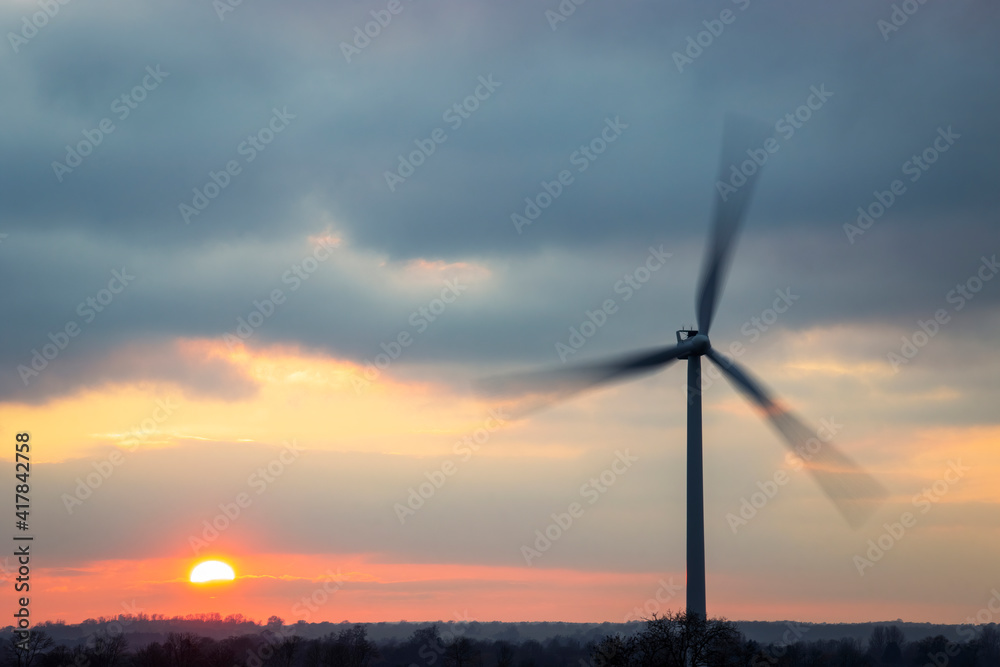Single wind turbine with beautiful sunset sky.