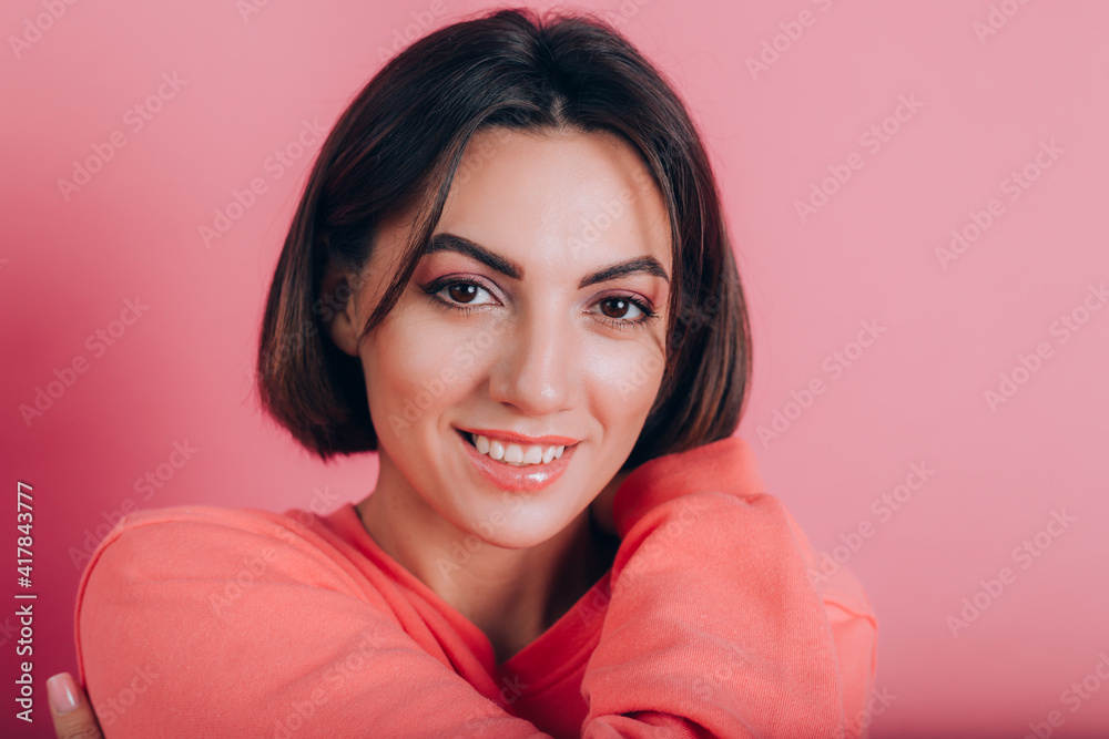 Smiling young woman 20s in casual clothes isolated on pink background studio portrait. Love concept. Mock up copy space. Keeping eyes closed holding hands crossed hugging herself Smiling young woman 20s in casual clothes isolated on pink background studio portrait. Love concept. Mock up copy space. Keeping eyes closed holding hands crossed hugging herself