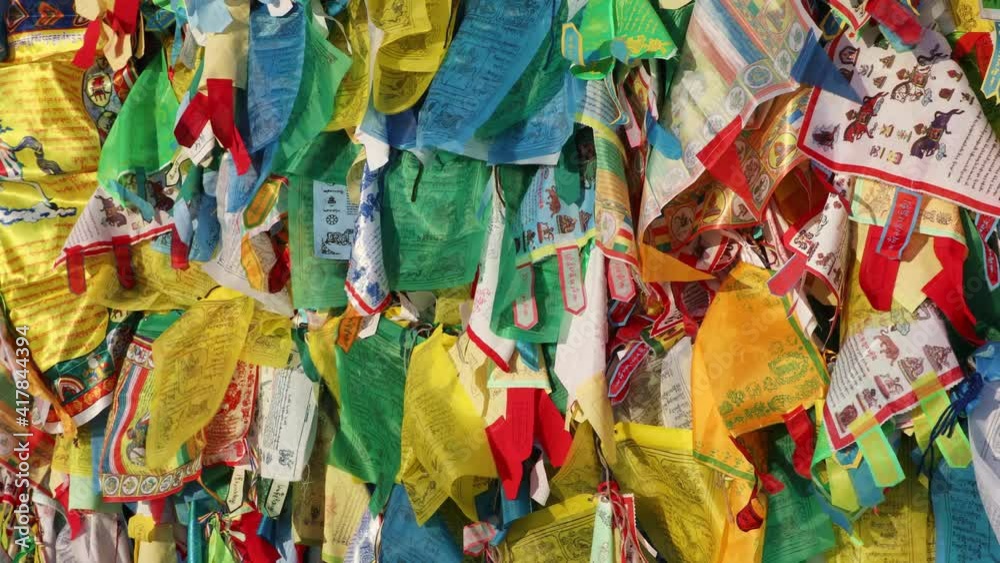 Full frame background of the wind horse prayer flags waving in the wind. The wind horse is a symbol of the human soul in the shamanistic tradition of Asia 
