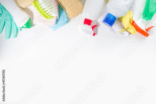 Spring cleaning background. Spring cleaning tools, utensils, accessories background, flatlay with hard light and dark shadows. On white background copy space