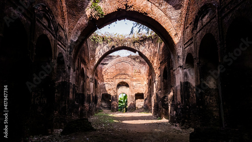 The arches in the overgrown ruins of an ancient dilapidated mosque in the town of Murshidabad in West Bengal  India.