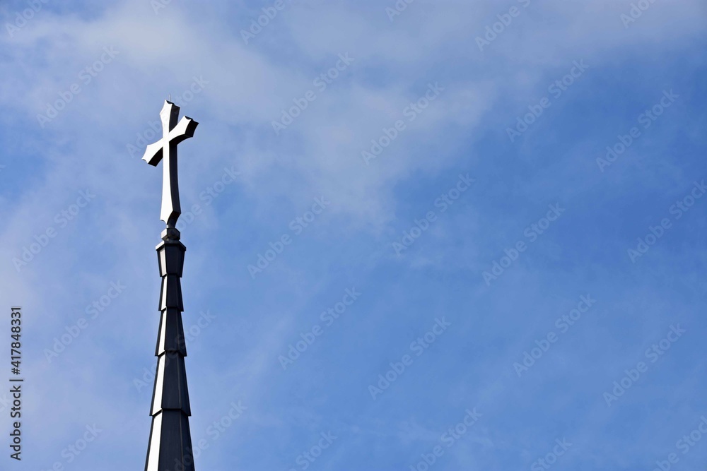 Church steeple on a hazy blue sky background