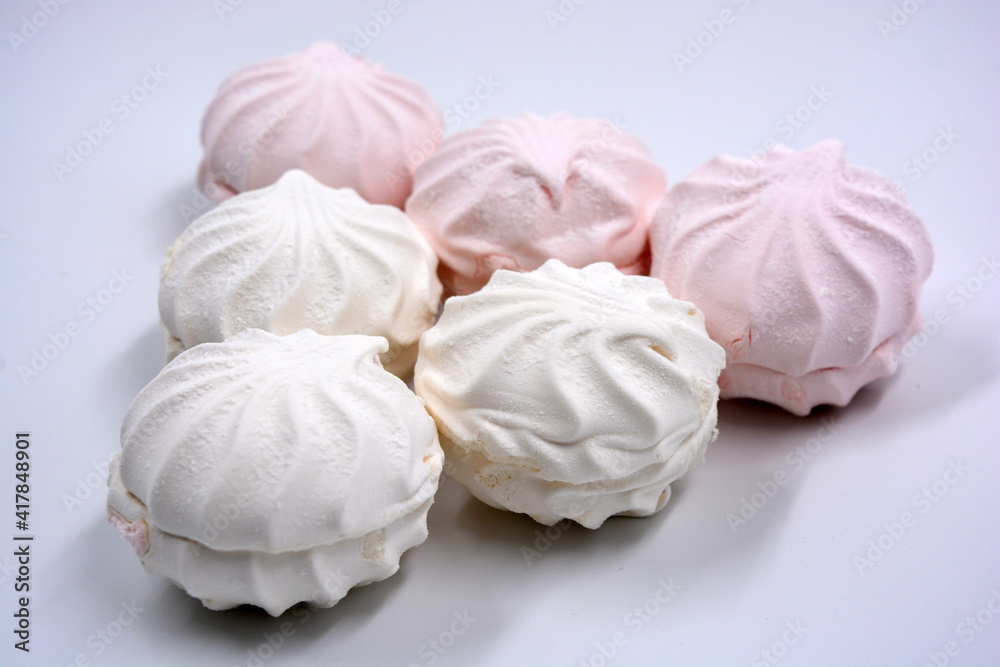 Beautiful and tasty air white pink marshmallow made in Ukraine is located on a white background. 