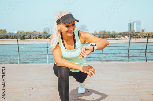 Woman looking at smartwatch heart rate monitor. Healthy lifestyle concept.