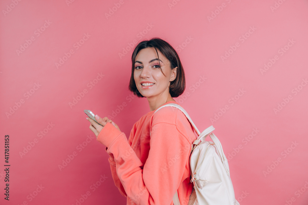 Young beautiful woman with smartphone. Smiling student girl going on a travel. Young beautiful woman with smartphone. Smiling student girl going on a travel.