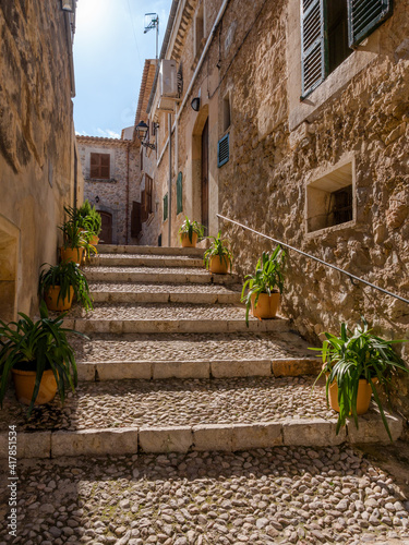 street with stairs and plants in the old town of Campanet, majorca, spain