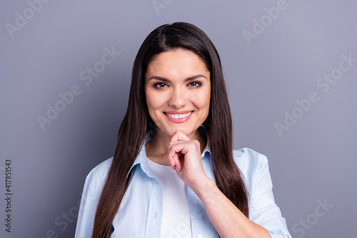 Photo of shiny charming mature woman wear formal shirt smiling arm chin isolated grey color background