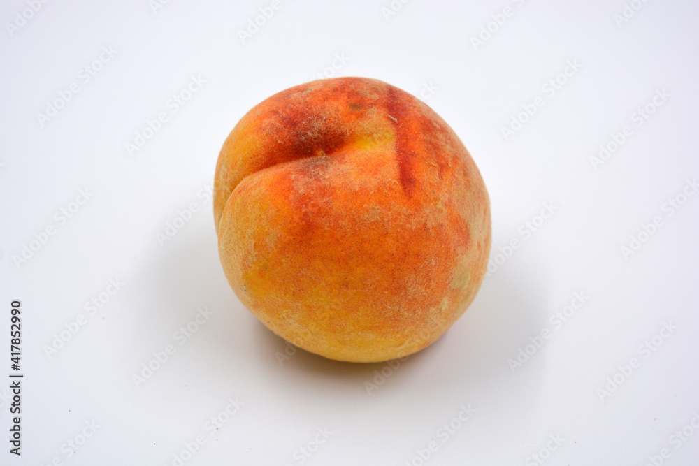 Tasty and useful fresh fruits, ripe red and orange peaches with a terry white skurt are located on a white background. Tasty and useful fresh fruits, ripe red and orange peaches with a terry white skurt are located on a white background.