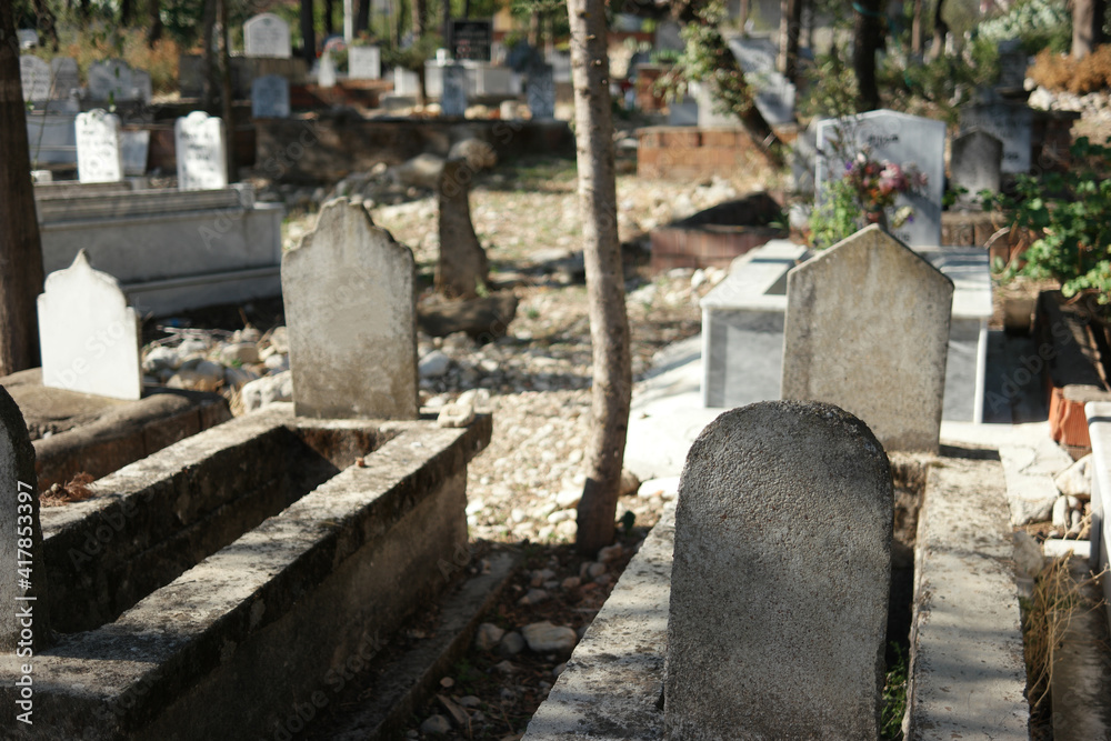 Muslim tombstones in graveyard. Graves with headstones at Muslim cemetery in summer season.