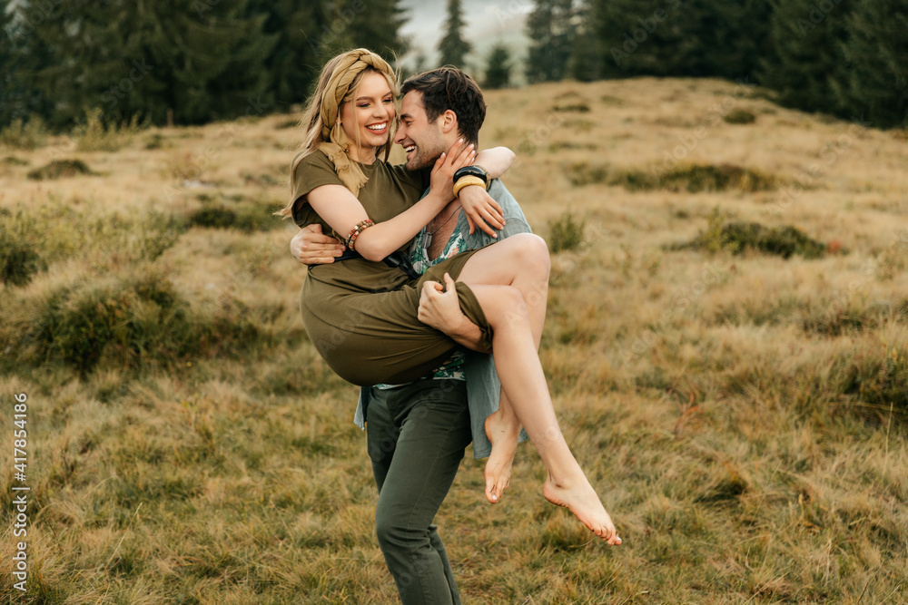 Young happy couple having fun in the mountains Young happy couple having fun in the mountains
