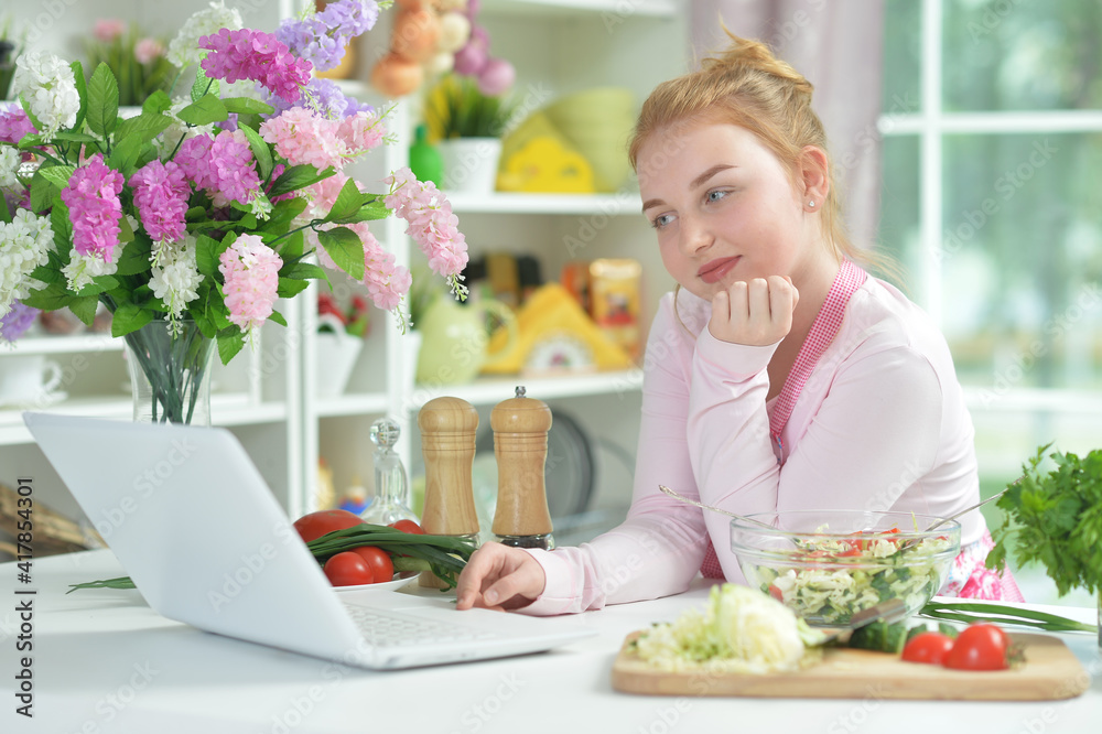 Cute teen girl using laptop